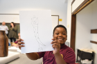 Davion Williams, 9, shows off his drawing. 