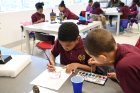 Raqual, aka "Rocky" Adams, age 9 (right), and Joshua Loyd, age 8, apply watercolors to their work.
