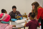 Hannah Quaintance (right) a graduate assistant with the UB Anderson Gallery and TA for the Museum Management course, and Alec Iacobucci, a graduate student in the course, talk with students about male and female ceremonial dolls from Cameroon.