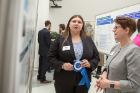 Sociology major Ashley Cohen (left) discusses her research with Ann Bisantz, dean of undergraduate education. Her poster was titled "Religiosity Concerning the Sea Following the Eruption at Thera: A Study in Minoan Marine Style."