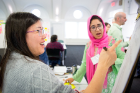 Tu Dam Le (left), a student in the urban and regional planning program, and Midhat Zehra, an undergraduate psychology student, are deep in discussion.