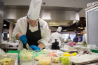 Jessica Arends, assistant executive chef, preps various ingredients for the UB team's menu.