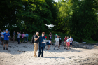 Piloting a drone as it takes off from the beach are Le Wang (left) and Nathan Dubinin, a research assistant for the Geo-Technology Experiences for Students and Teachers (GTEST) project.