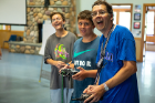 John Cerne (right) and campers fly the radio-controlled plane in the Jim Kelly House.