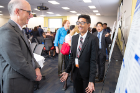 Priya Persaud (right) shares a light moment with Graham Hammill, vice provost for educational affairs and dean of the Graduate School, during the poster presentation session.