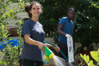From left: Second-year student Ilana Selli, a member of the orientation committee, and first-year student Neneyo Emmanuel Mate-Kole clean up and water at the Pelion Community Garden.