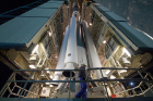 Workers prepare the Delta II rocket for launch. The rocket carries the ICESat-2 satellite on board. Photo: NASA/Bill Ingalls