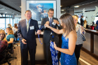 A UB Dazzler hands a whistle to guests including Ed Schneider (left), executive director of the UB Foundation.