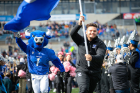Victor E. Bull leads the UB Bulls out onto the field before the game.