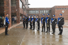 Members of the Thunder of the East marching band prepare to play the national anthem as the flag is raised.