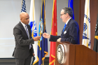 Dan Ryan, director of veteran services (right), presented a pin to Troy Miller, associate vice provost and director of admissions. Miller, who served in the Army and is a combat veteran, spoke about his experience in service and how good leaders embrace the concept of service over leading.