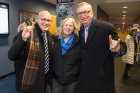 Flashing their horns-up signs are, from left, John Lambert, director of marketing and communications for Student Life; Jill Rexinger-Kuhn, assistant director of ticket operations for UB Athletics; and A. Scott Weber, vice president for student life.