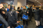Faithful fans line the hallway as the team walks through the lobby of the Murchie Family Football Center in UB Stadium.