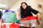 Sara Zeitler, vice dean for records, registration and financial aid in the School of Law, sets up the gifts donated by faculty and staff at the law school.