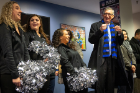 A. Scott Weber, vice president for student life, cheers on the team with members of the UB Dazzlers. Photo: Meredith Forrest Kulwicki.