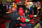 Linebacker Justin Mulbah and Jazmyne Burrow play a video game in the arcade before the bowling competition. 