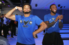Safety Tyrone Hill (left) flexes for the camera while linebacker Kadofi Wright applaudes a teammate.