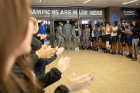 Members of the university community cheer some players from the men's basketball team as they walk through the lobby of Alumni Arena. Photo: Meredith Forrest Kulwicki