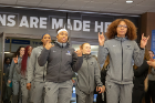 Some members of the women's basketball team give the "horns up" sign as they walk out of Alumni Arena. Photo: Meredith Forrest Kulwicki