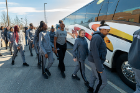 Members of the women's basketball team board their bus to begin their journey to Connecticut for the NCAA Tournament. Photo: Paul Hokanson