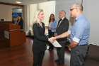 Lauren Gould, a candidate for BAs in psychology and sociology, shakes hands with Salvatore Rappoccio (PBK '99), associate professor of physics and a member of the PBK Elections Committee. Rappoccio taught inductees the secret PBK handshake. 