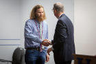 Nick Allen, an electrical engineering student, shakes hands with A. Scott Weber, vice president for student life.