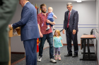 Christopher Wade, a biostatistics student in the School of Public Health and Health Professions, and his children, Rory, 3, and Bodhi, 9 months, visit with A. Scott Weber, vice president for student life.