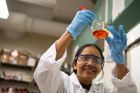 Chemistry PhD student Karthika Kadassery inspects her flask for bubbles and a color change, sure indicators that a reaction is taking place. 