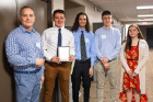 UB biostatistics professor Dietrich Kuhlmann poses with the third-place team from Grand Island: (from left) William Soos, Christian Whetham, Brady Hofmeyer and Kassidy Taylor. Photo: Douglas Levere