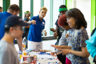 Andrea Greenwood, associate director of counseling services (center rear, in blue polo), points to the variety of snacks available.