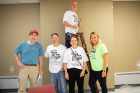 From left: Michael J. Tritto Jr., associate director of human services and operations for the University District Community Development Association, and UB volunteers Jay Stockslater, Brad Montroy (on ladder), Nancy Smyth and Andrea Proper.