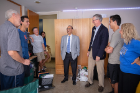 President Satish K. Tripathi (center) and A. Scott Weber (blue blazer), vice president for student life, visit a dorm room as students move in. Photo: Meredith Forrest Kulwicki