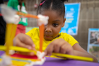 Five-year-old Tyanna works on her playhouse with a slide and a boat during the Imagine LaSalle public workshop Sept. 11 at Waterfront Elementary BPS #95.