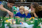 Teresa Bosch, an associate planner in the UB Regional Institute, brought her sons, Mateo (right), 4, and Lucas, 5, to the workshop. They are speaking with Andy Wisniewski, senior associate with Michael Van Valkenburgh Associates, the firm leading the conceptual design of the park.