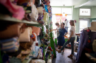 UB social work student Kristie Bailey (far right) and Xingyu Chen (center), a PhD student in Global Gender Studies, look over inventory at the Stitch Buffalo storefront on Buffalo’s West Side.