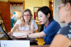 UB social work student Kristie Bailey (left) and Xingyu Chen (center), a PhD student in Global Gender Studies, review their recommendations for Stitch Buffalo.