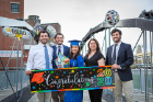 Victoria Guzman (center) poses with her mother, Laila​ Alkhatib, and brothers (from far left) Andrew Alkathib, Rob Kyne and Alexander Alkathib at Canalside in downtown Buffalo to celebrate her graduation from the College of Arts and Sciences on May 16. Photo: Douglas Levere 