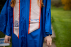 Her robe was a gift from Dad; the stole was provided by Tim Matthews, an adviser with the Honors College.
