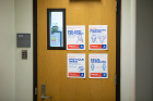 Health and safety posters remind the community of behavioral expectations inside campus buildings. Photo: Douglas Levere