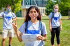 Puja Shah gives the horns up as she poses with other students who participated in Operation Doorhanger. Photo: Douglas Levere