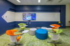 This area for small team meetings features a large, wall-mounted screen and seating with fold-out desk surfaces. Photo: Douglas Levere