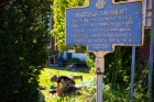 A New York State historical marker near the Michigan Street Baptist Church, where an archaeological survey is taking place. UB anthropology students can be seen digging at left.