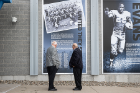 Two team members look at an informational display about the team outside UB Stadium. The team, which won the Lambert Cup, declined an invitation to play in the Tangerine Bowl because Black teammates Willie Evans, shown at right, and Mike Wilson were not allowed to play in the game.