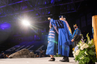 A graduate gets hooded. Photo: Meredith Forrest Kulwicki