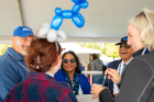 On Saturday before the game, President and Mrs. Tripathi mingle with fans.