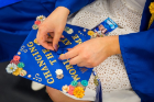 A student decorating their graduation cap.