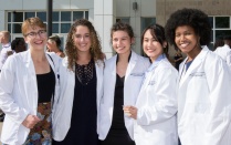 Students in white coats. 