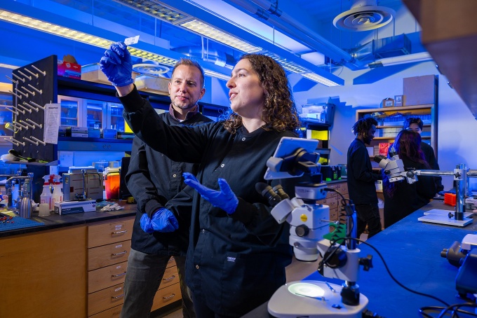 Paul Meyer work with students in his lab.