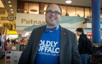 UB employee showing off his university pride in a Boldly Buffalo t-shirt and UB pin on his lapel. 