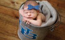 a new born baby in a UB branded bucket. 